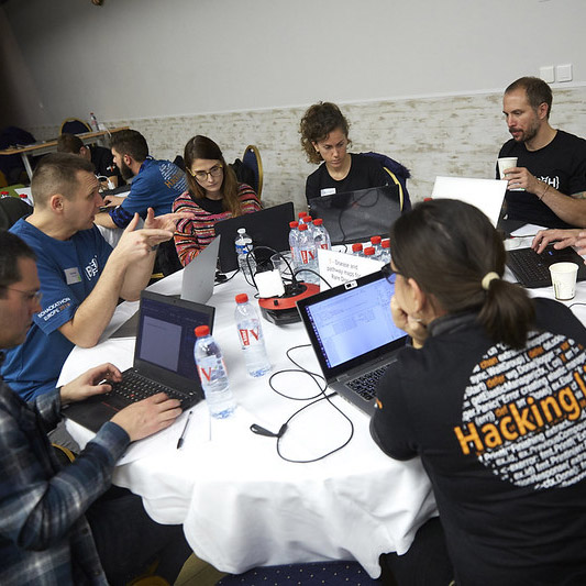 Six hackers discussing their project